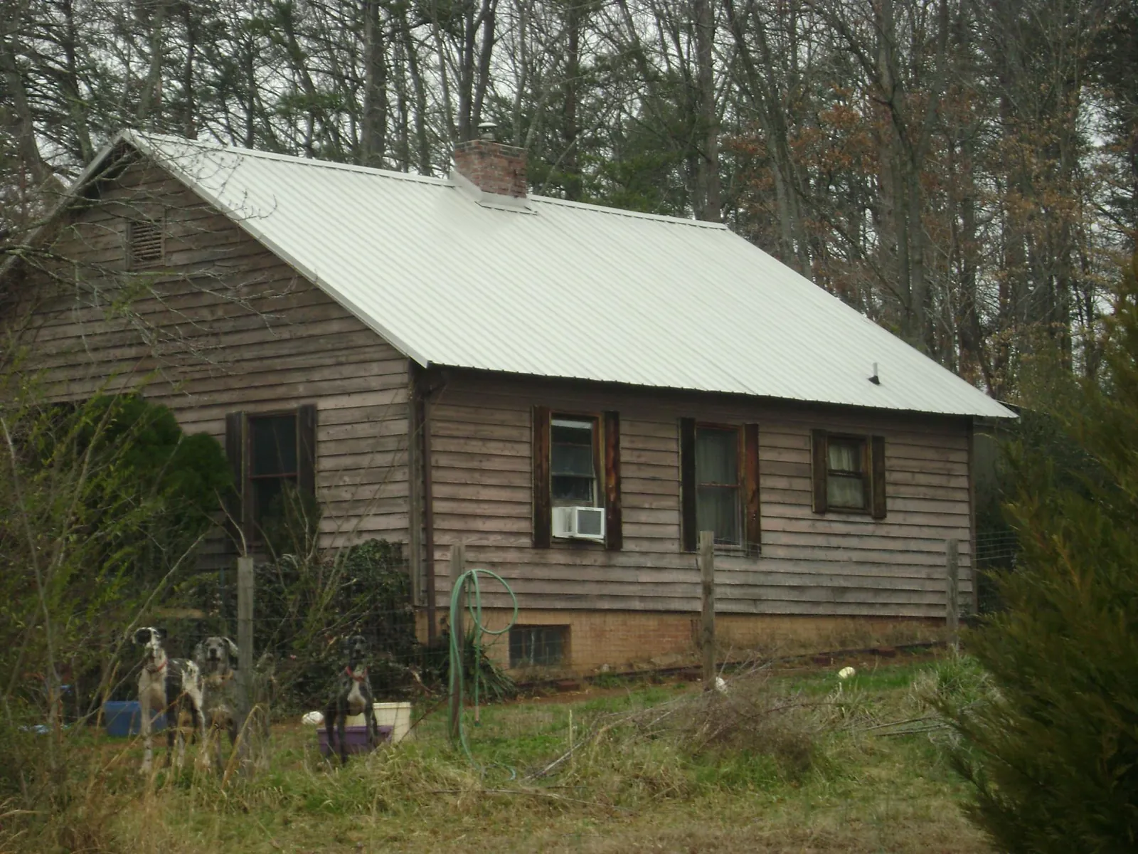 White metal roof on an old wood sided farmhouse, from a Metal Roof Installation job in Verona Beach